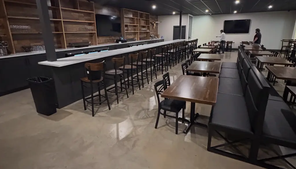 Restaurant dining room in Starkville with a sealed polished concrete floor and a long bar