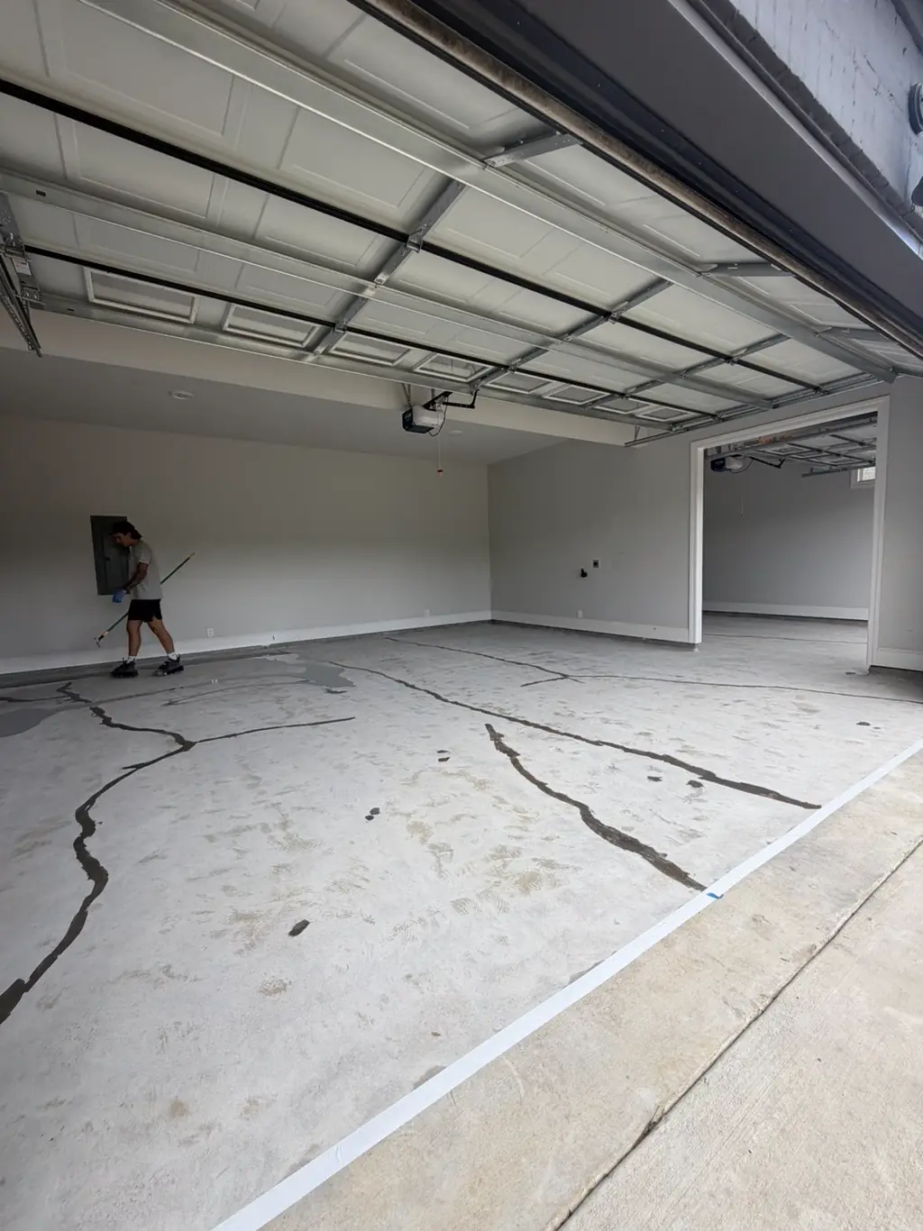 Badly cracked garage slab before crack repair and diamond grinding