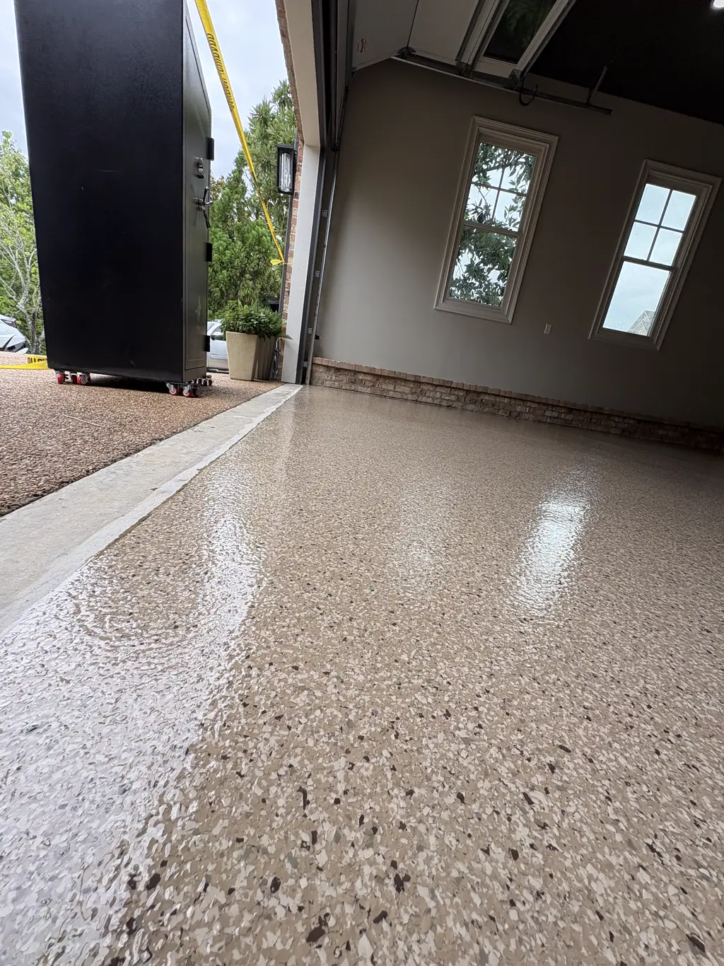 Exterior walkway coated in flake leading to a covered entry
