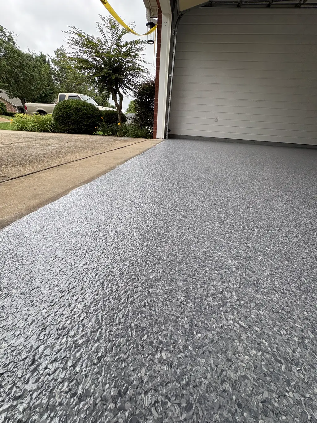 Garage and driveway apron coated in matching gray flake